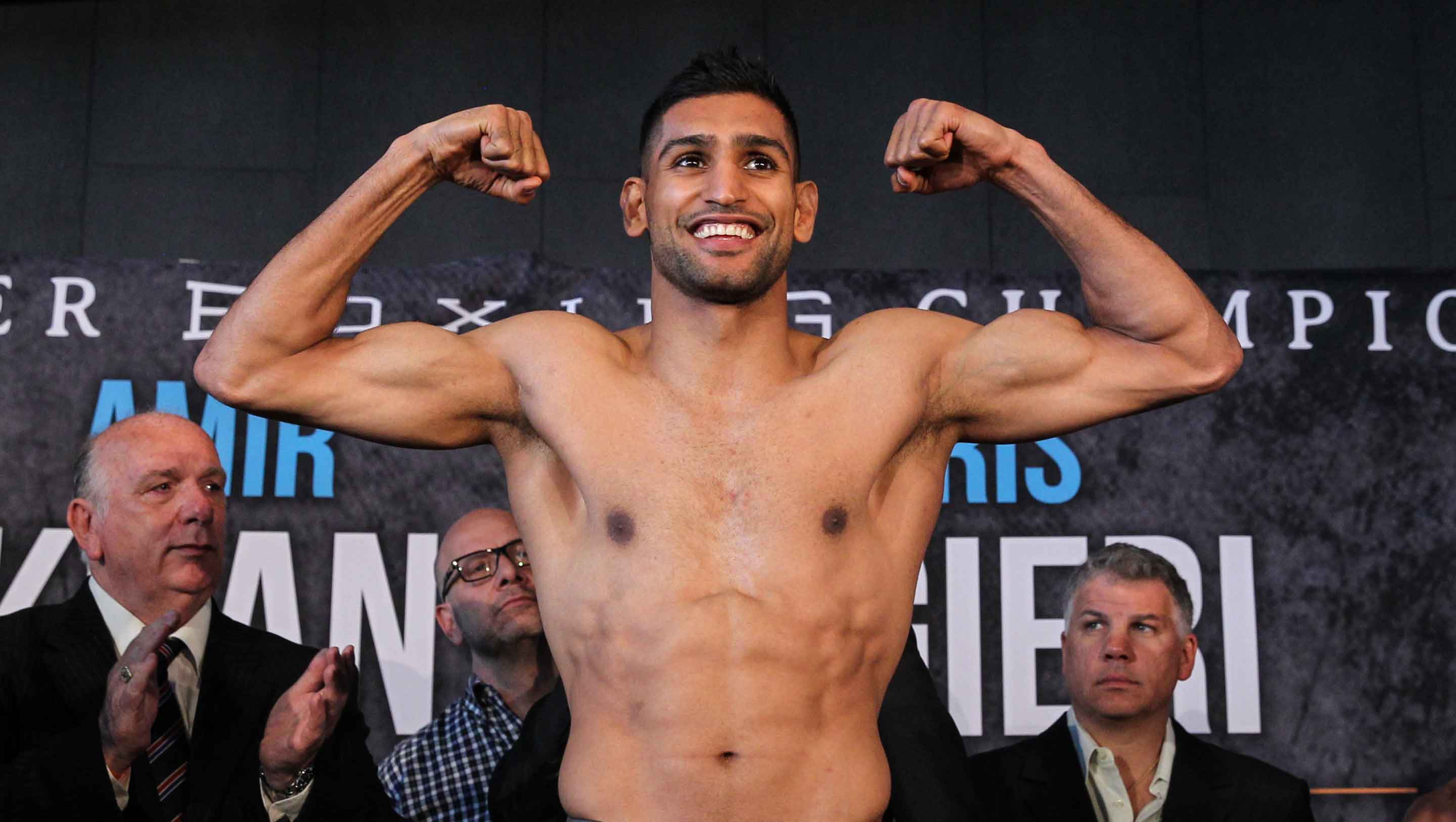 Khan makes weight